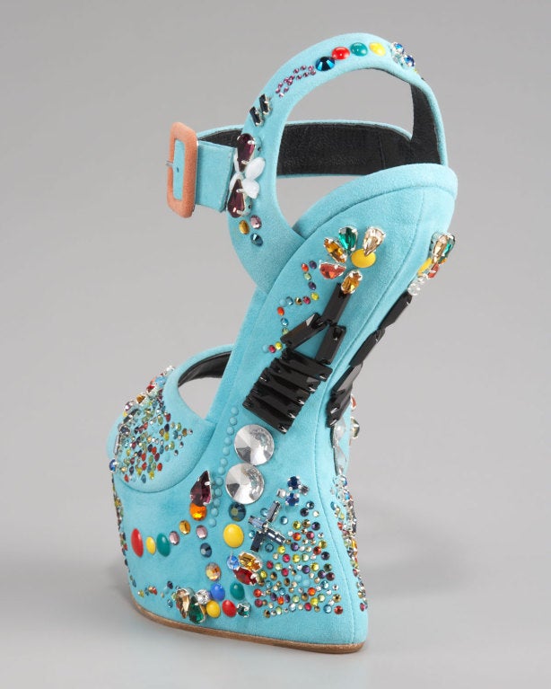 GIUSEPPE ZANOTTI
Blue No Heel Crystal-studded Sandal

Suspend your disbelief. As if pinched inward by an unseen hand, this Giuseppe Zanotti sandal's wedge heel creates the effect of walking on air. Candy-colored crystals complete the whimsical