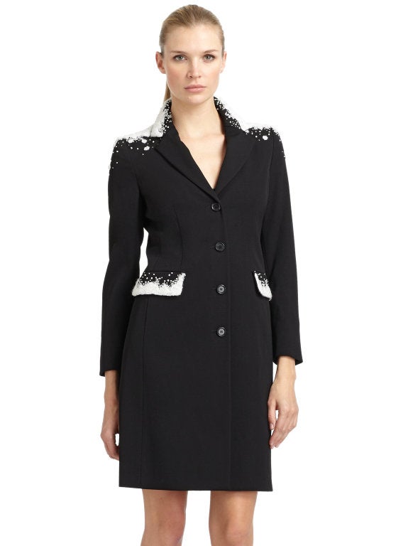 MOSCHINO

Black Snow capped Wool Gabardine Coat
Embroidery, beads and sequins create a snow motif on the shoulders and flap pockets. Notched lapels. Button front and cuffs. 

Wool. Fully lined. Made in Italy.

Brand new, with tags. 

Size: 

IT 44-