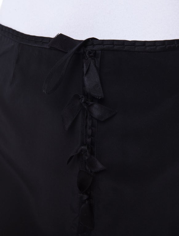 Tom Ford for Yves Saint Laurent Black Silk Ribbon Skirt

Black silk skirt with ribbon detail throughout and hook and eye closures at side.
Measurements: Waist 30 inches, Hip 37 inches, Length 25 inches
Fabric Content: 100% Silk
Fully lined with