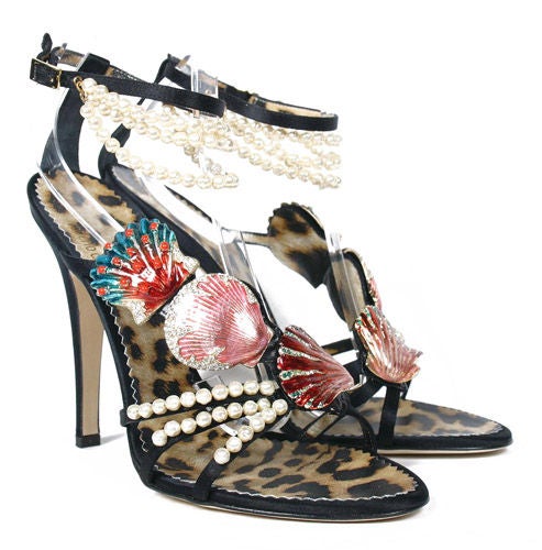 ROBERTO CAVALLI SHOES
Celebrate glamorous times with ROBERTO CAVALLI's chic, high-heeled sandals.

Black silk is embellished with jeweled enamel seashells
An elegant strap with pearls wraps around the ankle while vibrant leopard print insoles add