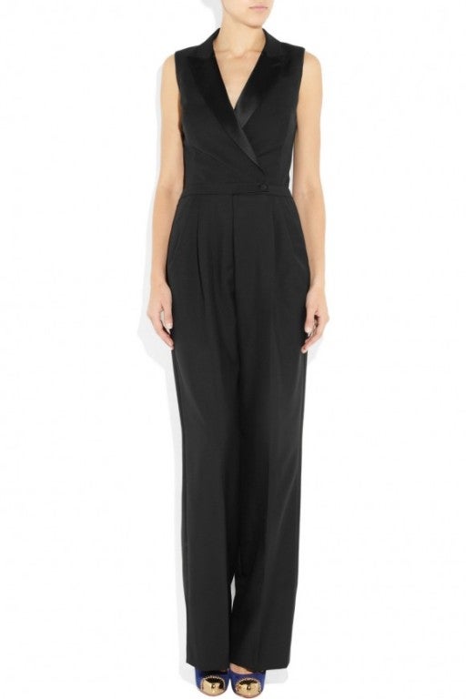 Alexander McQueen's boy-girl inspired wool and silk-satin tuxedo jumpsuit is a modern take on tailoring. Cover up by day with a cropped jacket, adding a sculpting waist belt and platform heels for an impeccably sharp after-dark silhouette. 


