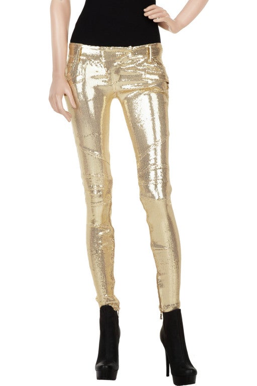 Balmain gold sequin-embellished skinny pants with gold zip fastenings along the inner sides. The pants have an extended tab at waist with a concealed zip and hook fastening, zip-fastening slit pockets at front and back, three slit pockets at front,