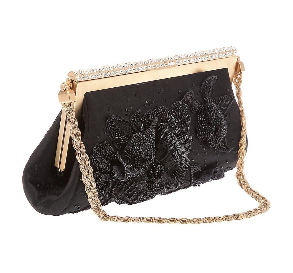 VALENTINO

Black clutch bag from Valentino featuring beaded detailing, 

a gold-tone frame 

with a diamante embellished closure. 



Gold-tone plaited strap.


Measurements: Shoulder Strap 18?, Height 5?, Width 9?, Depth 3.5?

Made