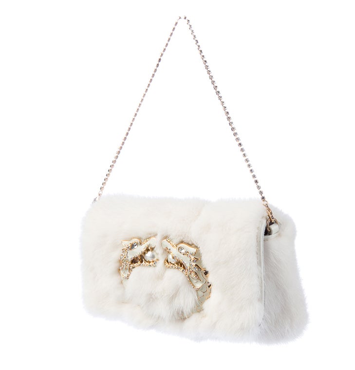 HIGHLY COLLECTIBLE GUCCI MINK FUR CLUTCH 

CREATED BY TOM FORD

 
White mink clutch with gold-tone hardware, removable crystal strap, embellished dragon at front and magnetic closure at flap. 

Includes original dust bag.

Excellent