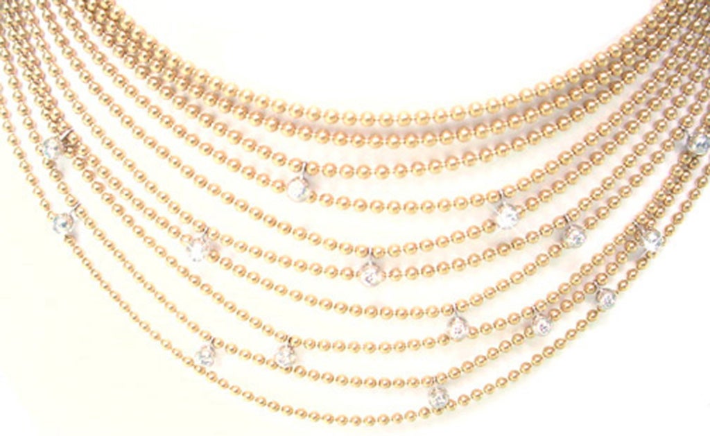The stunning neckpiece from Cartier's Collection Draperie de Decollete is no longer in production. composed of 18Karat yellow gold beads adorned with 15 F-G VS diamonds for a total of 1.25 Carats. The 10 strands of 2mm beads in cascading lenghts,