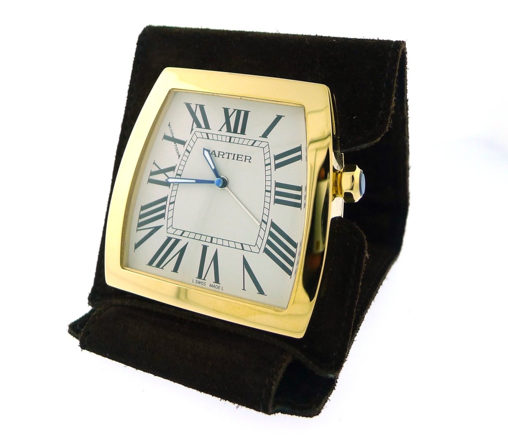 ITEM: 	  	Cartier Santos Travel Alarm Clock
MODEL #: W0100064 
COVER: 	  	Brown Suede
MOVEMENT: 	  	Quartz
CASE MATERIAL: 	  	Yellow Gold Plated & Stainless Steel with Blue Cabochon Stone
SIZE: 49 x 49mm closed