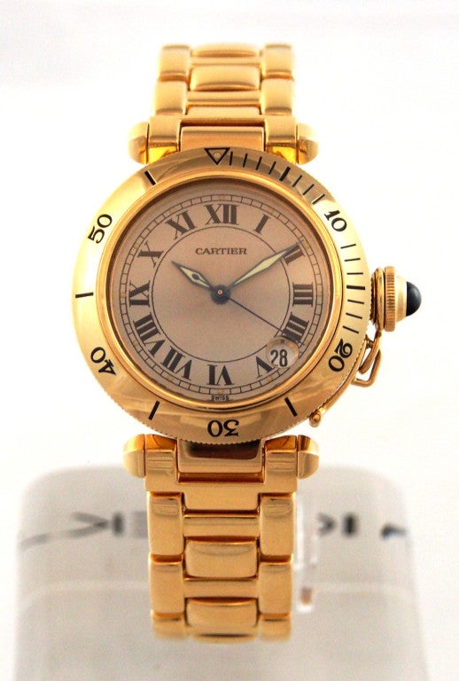 Brand Name: Cartier
Style Number: 1035
Series: Pasha
Gender: Unisex
Case Material: 18K Yellow Gold
Dial Color: White Roman
Movement: Automatic
Functions: Hours, Minutes, Seconds, Date
Crystal Material: Scratch Resistant Sapphire
Case