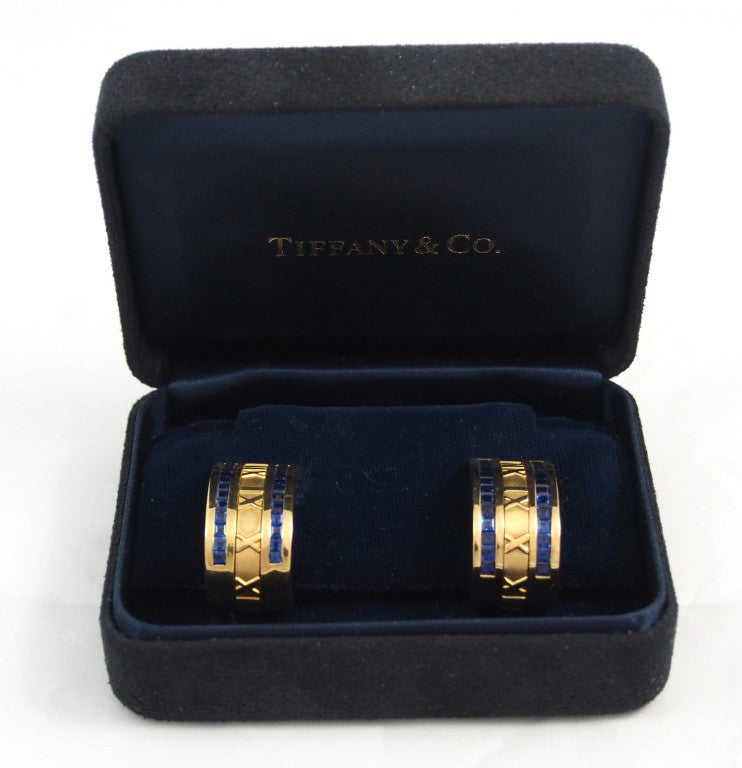 Brand Name: Tiffany & Co.

Series: Atlas Earrings

Gender: Lady's

Case Material: 18K Yellow Gold

Stones: 2 Rows of Invisible Set Blue Sapphires on Each Earring (64 total sapphires)

Backing: French Clip Backing

Total Weight: 13.8