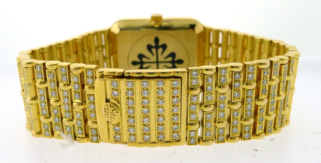 Patek Philippe Ladies 3823-8 18k Yellow Gold watch with Diamonds & Emeralds.  Pave diamond dial with emerald hour markers. Quartz movement with hours/minutes. Sapphire crystal. 30mm x 25.5mm diameter. 18k Yellow Gold pave diamond bracelet. Approx.
