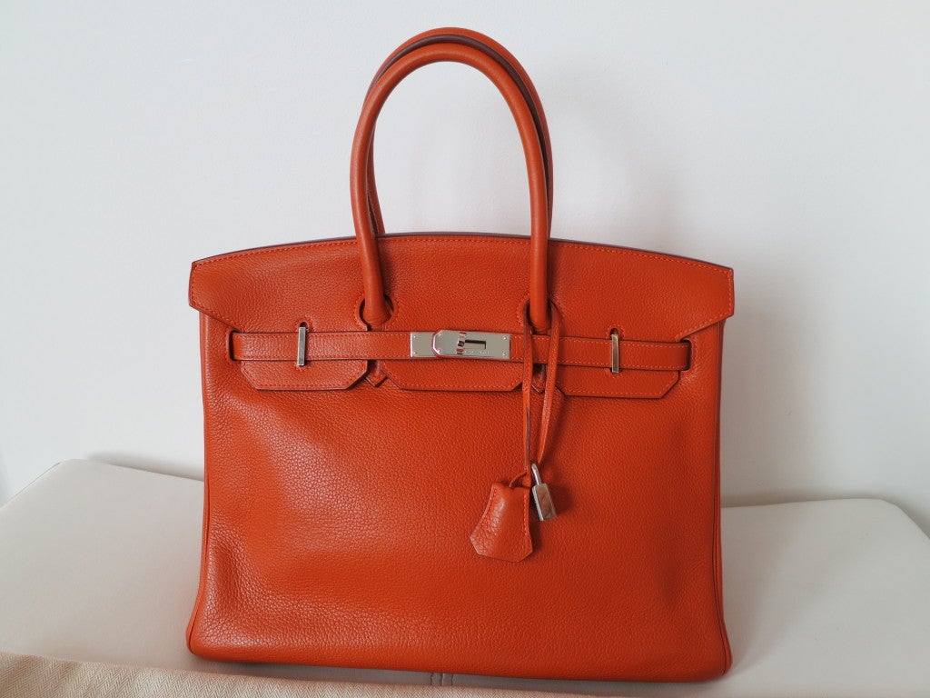 Amazing classic pumpkin orange birkin bag with palladium hardware. Pre-owned and just came out of the Paris Hermes spa.... Plastic still on the hardware.
Excellent condition. This bag comes with lock, keys, clochette, a sleeper for the bag, rain
