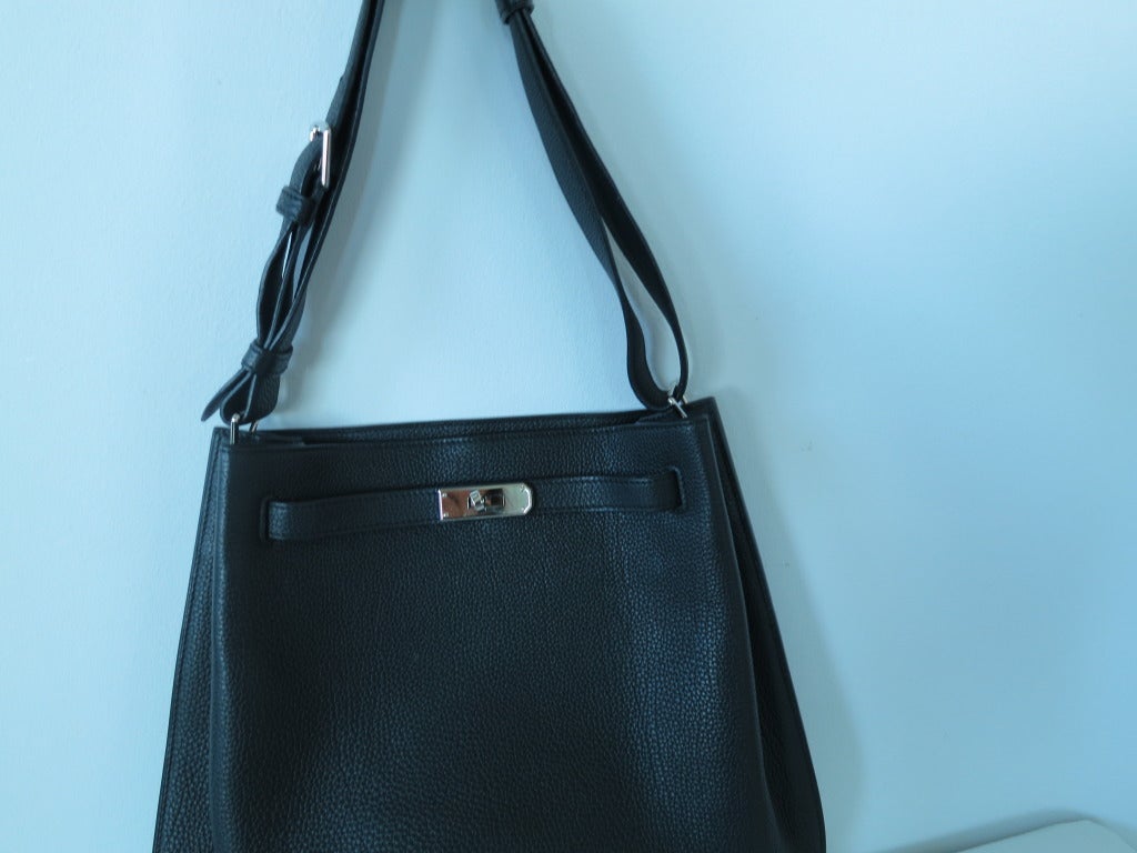 The So Kelly Tote in Black Togo leather with Palladium
Hardware. The shape is the perfect tote. Long, roomy with interior zipper pocket and slip pocket. Comfortable to wear with adjustable strap. The to go purse to put everything in and easy to