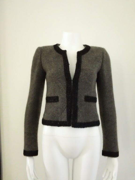 Classic Chanel cashmere and alpaca jacket. Grey with black trim will stay in your closet forever. Combine it with a skirt and blouse, pants or just a tee with jeans. Easy and luxurious.....