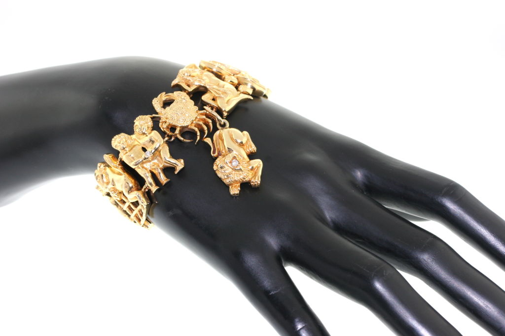 A fabulous and rare 18k gold bracelet by Tiffany depicting each sign of the zodiac. Suspended is the sign of the Lion (Leo) but any sign can be substituted in it's place. A flexible and whimsical piece each sign is beautifully detailed and some are