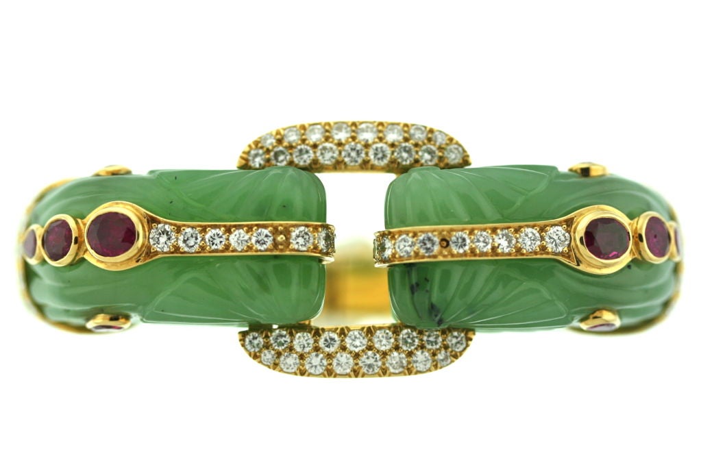 An exquisite and important David Webb hand carved jade bangle bracelet of a confronting chimeras motif set with faceted burma rubies and diamonds in 18k gold. These older David Webb creations are stunning and rare. This piece is in perfect condition