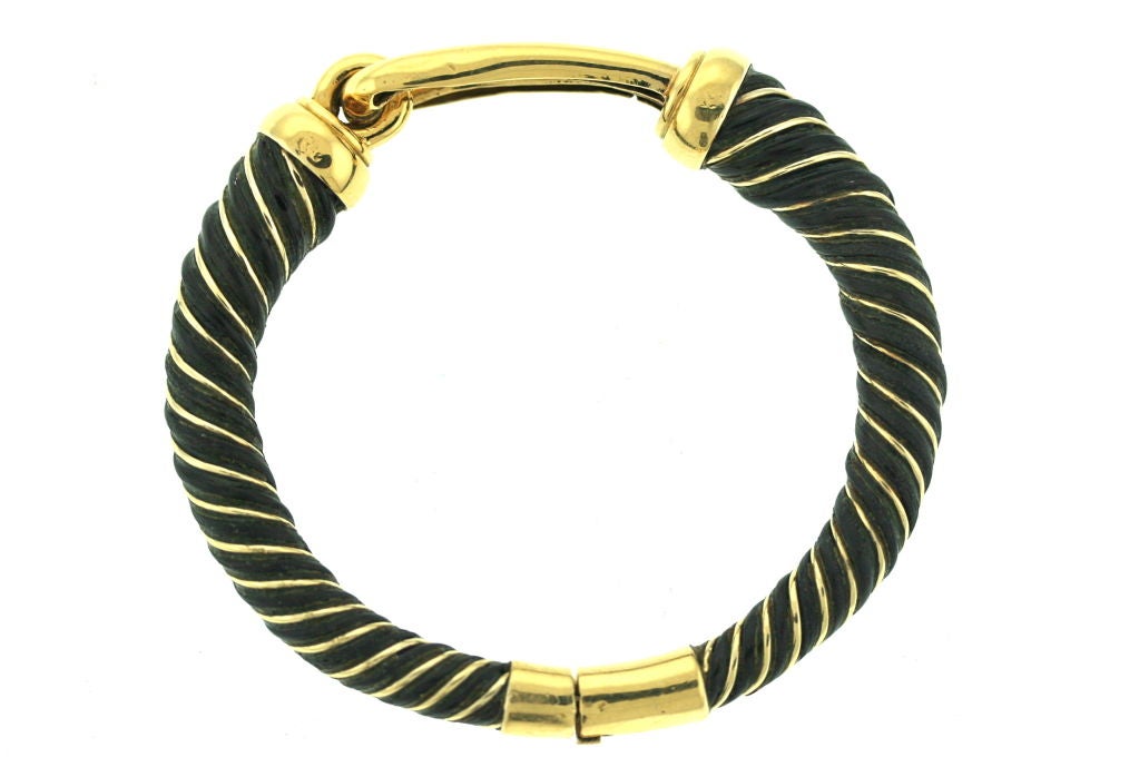 Beautiful bangle bracelet of twisted 18k yellow gold and elephant hair. A great piece to pair with a plain gold bracelet or a bracelet of another organic material such as wood.