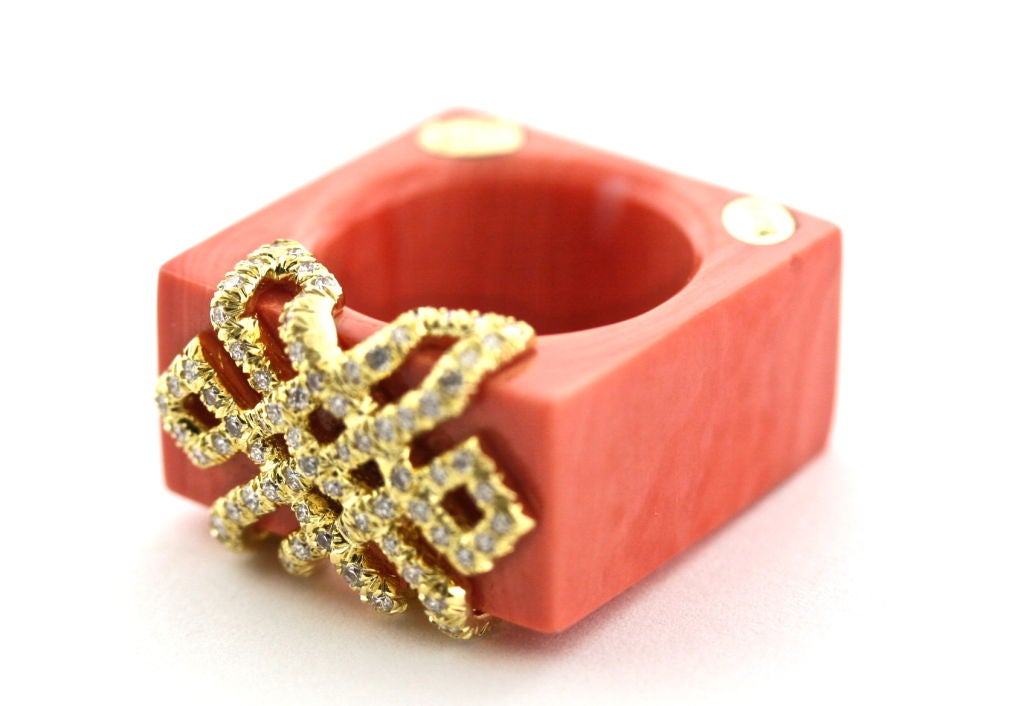 Chic and chunky Henry Dunay cocktail ring hand carved form one piece of coral embellished with a geometrical 18k gold design inset with .61 carats of diamonds. Extremely comfortable to wear. Size 7.5. Can be made smaller but not larger.