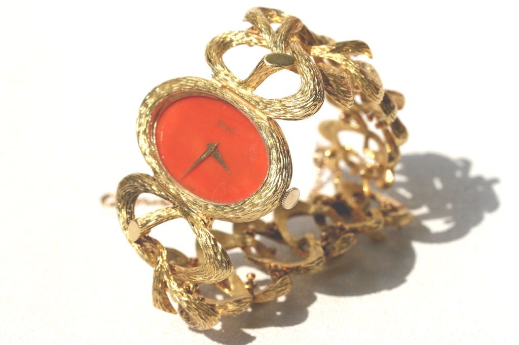 Piaget 18k textured gold bracelet watch with coral face designed as a series of intertwining 