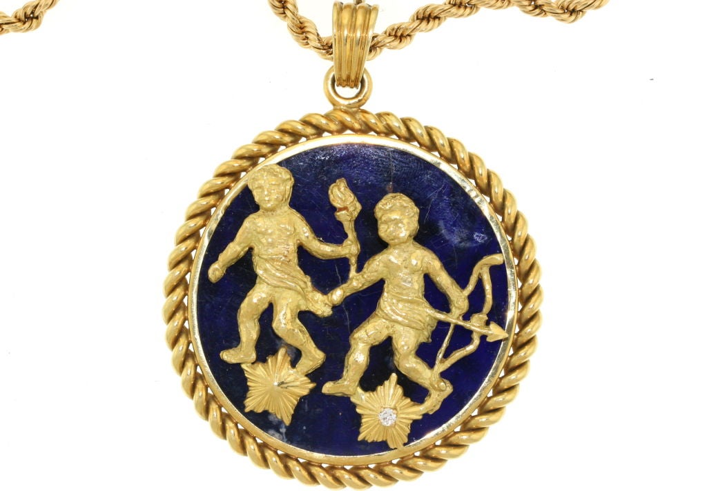 A fabulous zodiac medallion from the 1970s by Van Cleef & Arpels. The symbol for Gemini, the twins, is set in 18k gold with a single diamond in the star and mounted on lapis stone. The bale opens and closes allowing this pendant to be worn on