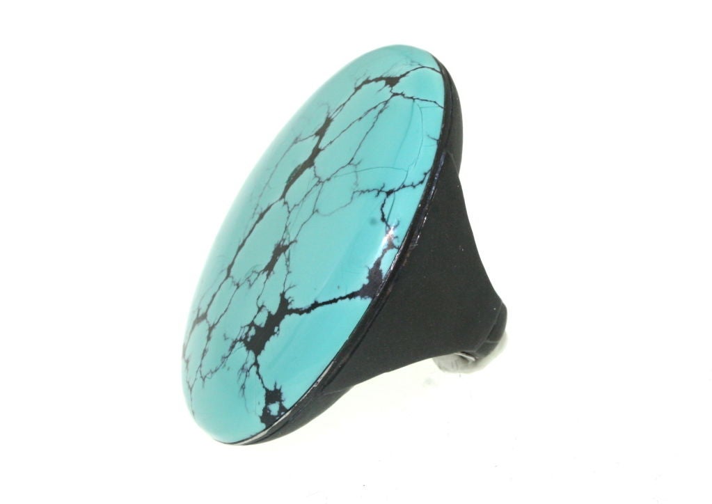 A wonderful art deco turquoise ring set in gunmetal by Marsh and Co. The elegance of this ring is the simplicity of the mounting and its compatibility with the interesting markings and unembellished presentation of the turquoise stone. The asthetic