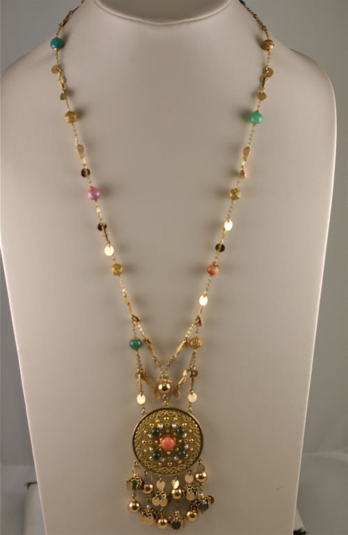 Malaysian 1960s 18k and 14k gold long necklace embellished with coral, jade, lapis, rose quartz, rhodochrosite, pearl and filigree balls interspersed with gold discs to create a very fun and festive casual look. The movement of this piece is chic
