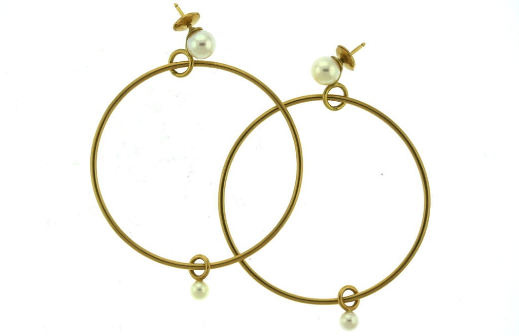 Hermes 18k large gold hoop earrings with pearl tops and pearl floating pearl drops. Big and stylish hoops will forever be a classic piece to colle ct. These hoops are expecially great because they don't stick out as many hoops do. The posted pearls