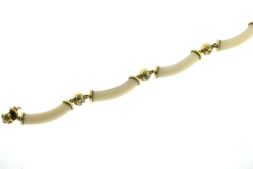 Van Cleef & Arpels 18k gold flexible bracelet designed as a series of tubular shaped ivory sections joined by gold balls inset with seven diamonds in each ball. 7.5