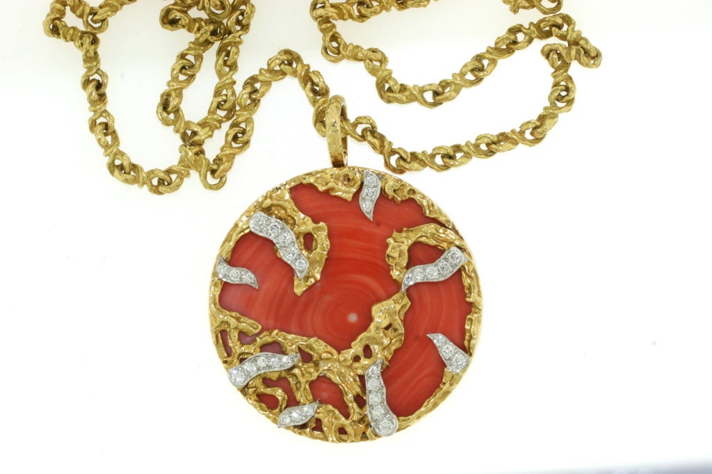 A glorious Kutchinsky long 18k textured gold coral and diamond pendant suspended from a matching 18k gold long chain of beautifully crafted and textured links. This is an exquisitely made piece of jewelry that is solid and extremely well designed.