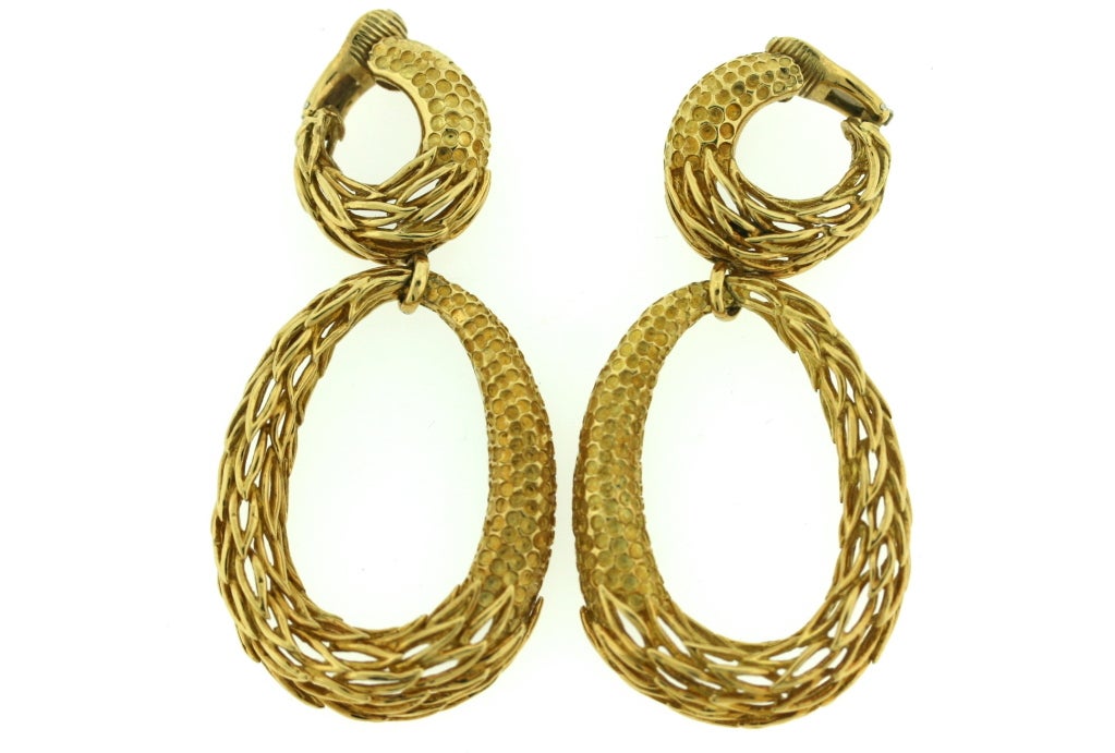 A very stylish pair of dangling double hoop ear clips from Cartier. Designed as a clip-on top with an articulated hoop drop measuring 2.75