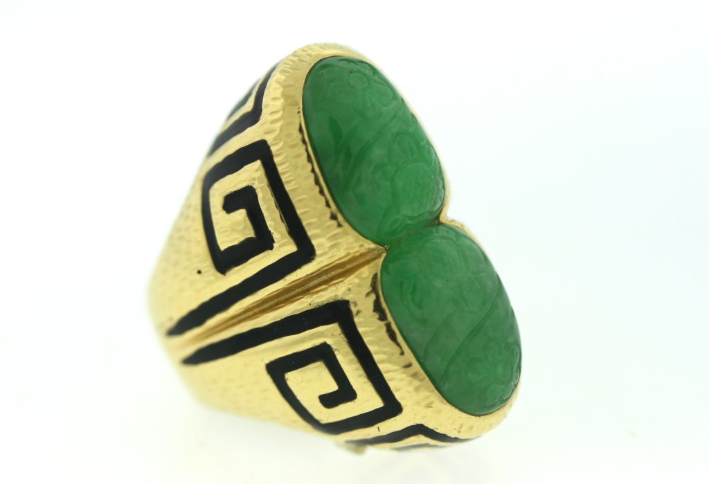 David Webb 18k hammered gold ring with two carved jade stones framed in a greek key jet black enamel design. The scale of this ring is wonderfully large and chunky yet the width is not at all overwhelming so the ring flatters every hand. The length