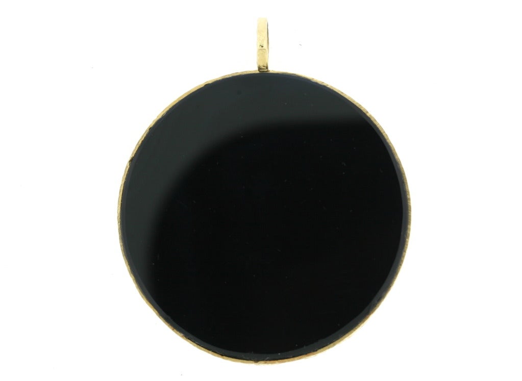 Kutchinsky 18k gold pendant circa 1970s with inset black onyx disc. The gold work on this piece was done in true 1970s fashion. A very stylish period piece. 2.25