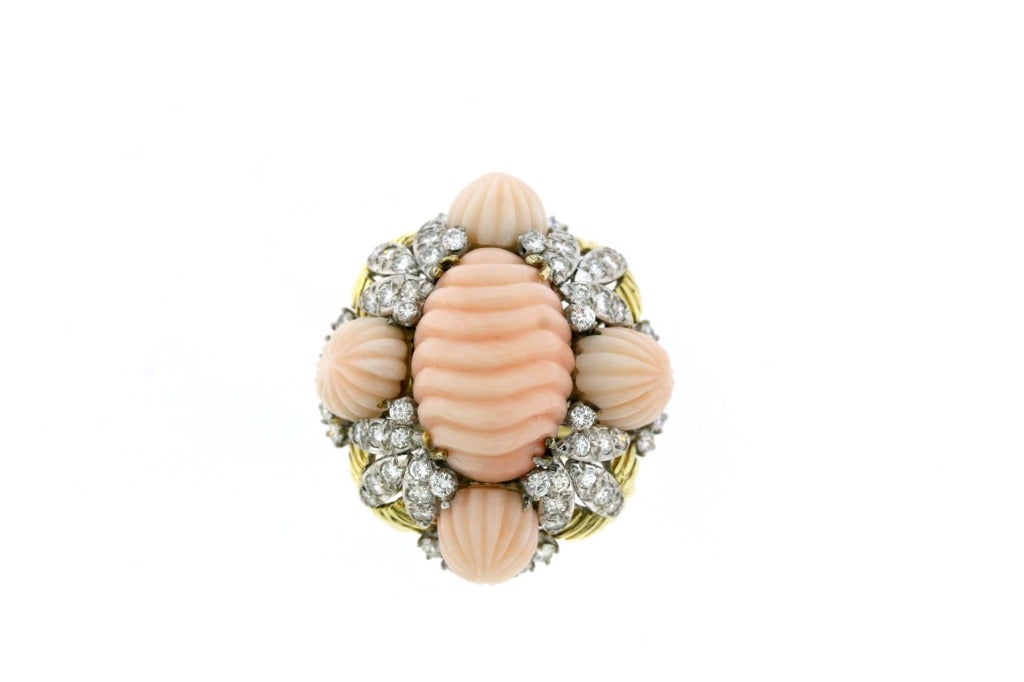 Hammerman Brothers 18k gold cocktail ring with a chunky, bold and organic presence. A real statement piece from the 1960s designed as a large carved coral center surrounded by four matching stones and leaf-like clusters of diamonds. 64 diamonds