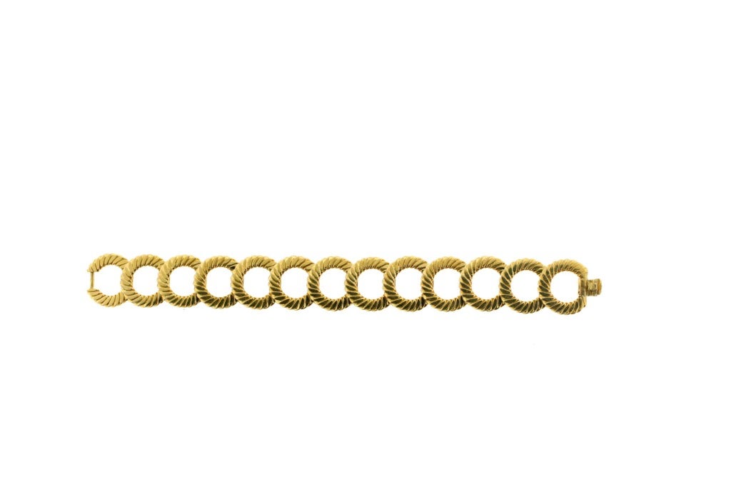 Van Cleef & Arpels 18k gold interlocking circular link bracelet, 7 inches in length. Width of .75 inches. Signed Van Cleef & Arpels Made in France with French hallmarks present.
