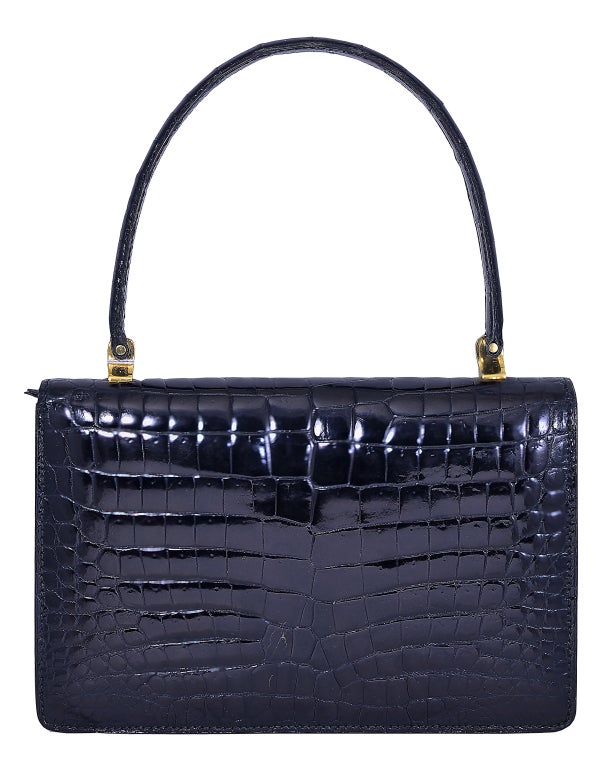 Truly a classic!  This is a gorgeous, black,  Lederer, French baby alligator handbag.  Everything about it is perfection!  The design, the size, the skins....just a classic.  Outside skins are beautiful, inside has slight wear to the top of one