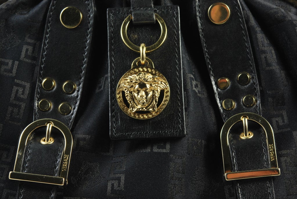 Gorgeous Versace tote, created of Versace imprinted signature Greek Key fabric with signature, gold tone Medusa head on center of handbag.  Handbag is not extremely structured and will hold a substantial amount.  Approximately 12