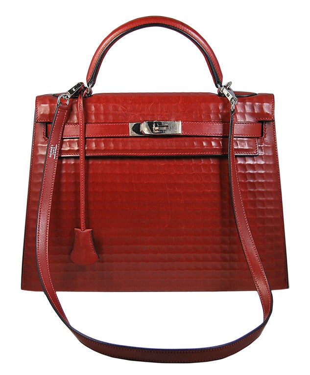 RARE 32cm Hermes square waffle pattern Box leather in fabulous brick red color.  Box leather does have a tendency to scratch more easily than other leather finishes, however, it is also the easiest to bring back to new.  This bag has some minor