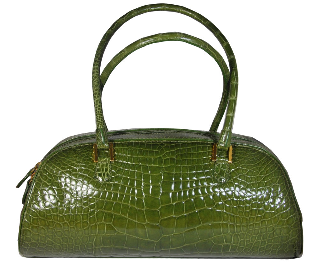 Gorgeous Lana Marks olive green genuine alligator bag. It has a double zipper closure as well as a zippered and unzippered compartment inside. The measurements are 14 3/4