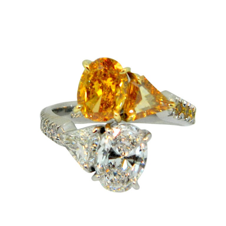 Fancy Vivid Orange-Yellow and D Internally Flawless Oval Diamond Bypass Ring