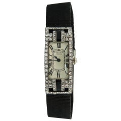 Antique Cartier Lady's Platinum, Gold, Diamond, and Onyx Art Deco Wristwatch circa 1920s