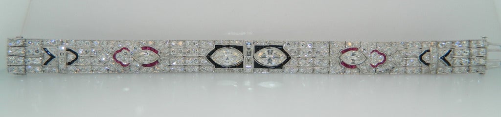 An absolutely fabulous, 1920s Art Deco, Diamond, Ruby, Onyx and Platinum Bracelet.  This stunner of a bracelet is in excellent condition and features superb craftsmanship.