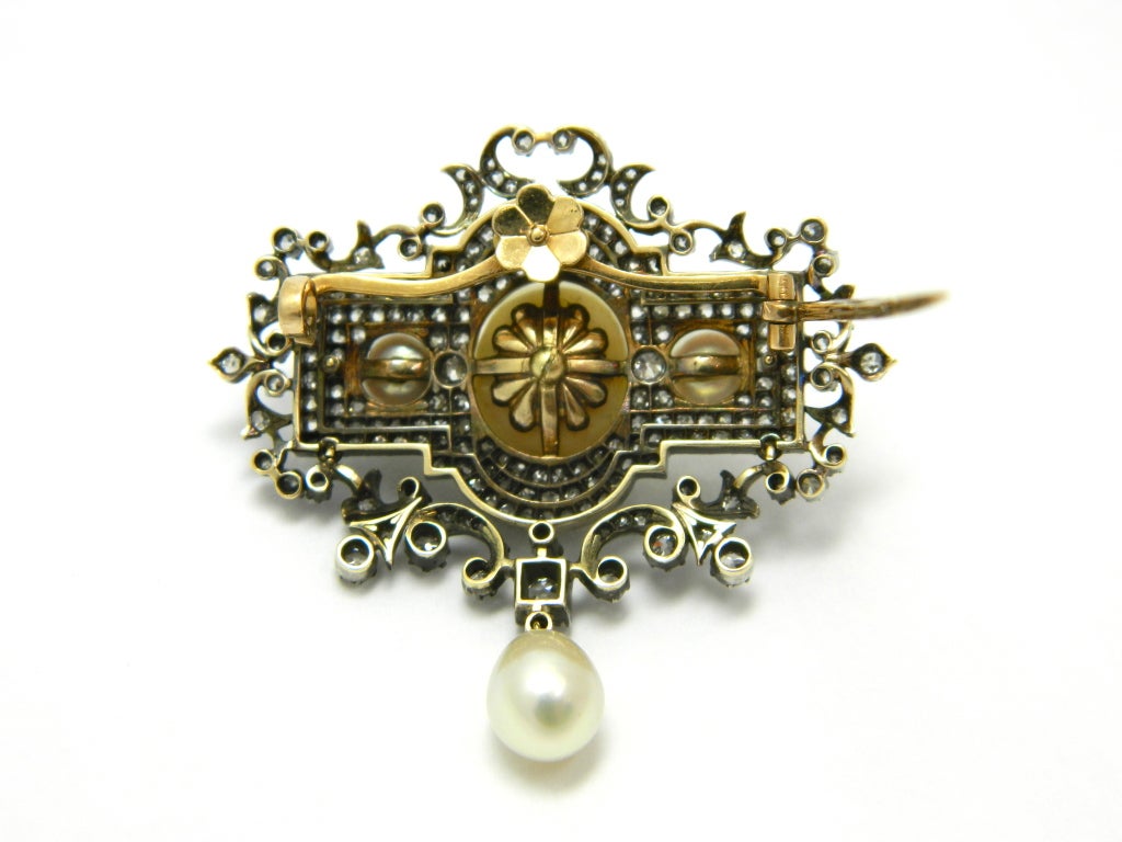 A magnificent, early Victorian, silver topped gold, GIA certified natural saltwater pearls, and diamond pendant/brooch with interchangeable pin stem and pendant stem