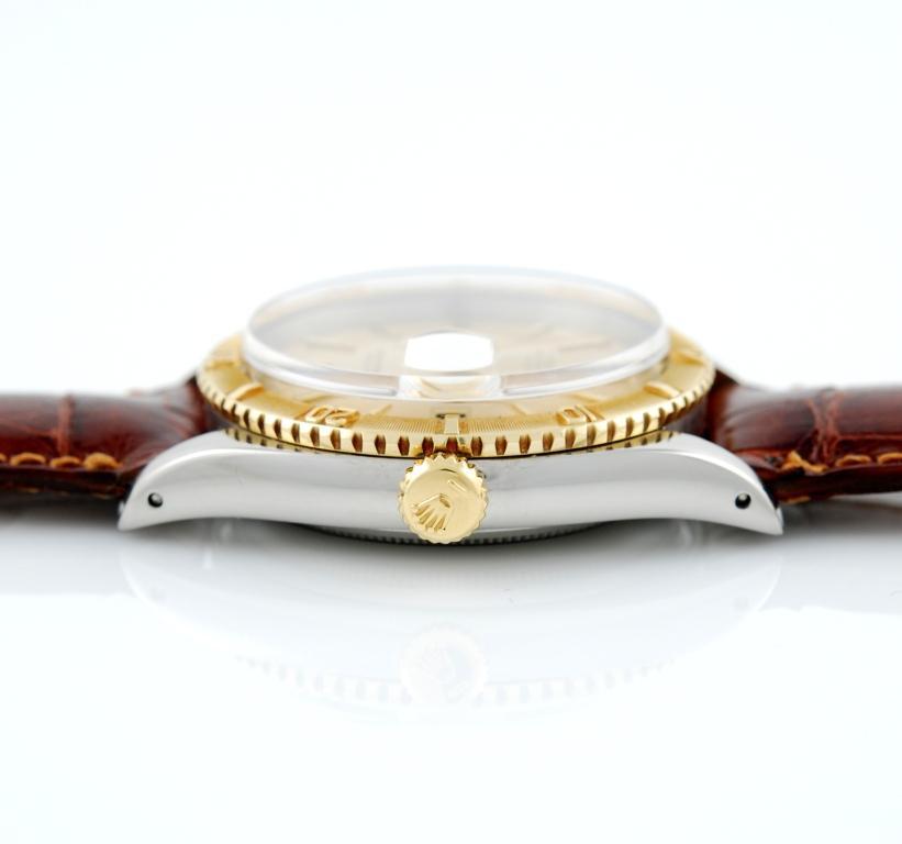 18k yellow gold and stainless steel Rolex Datejust, circa 1958, Ref. 6609, with rotating calibrated bezel. Champagne dial with yellow gold applied indexes and alpha hands. Plastic crystal, date at 3 o'clock. Automatic movement. Yellow gold and