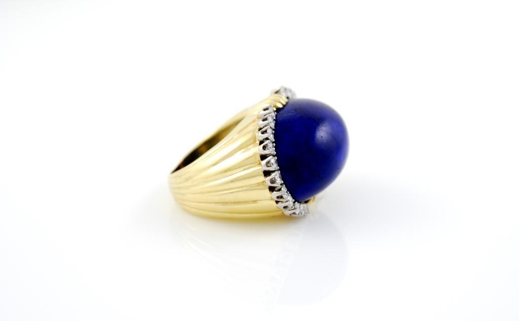 Lapis lazuli dome on an 18kt yellow gold shank surrounded by approximately 1ct of diamonds mounted on platinum.