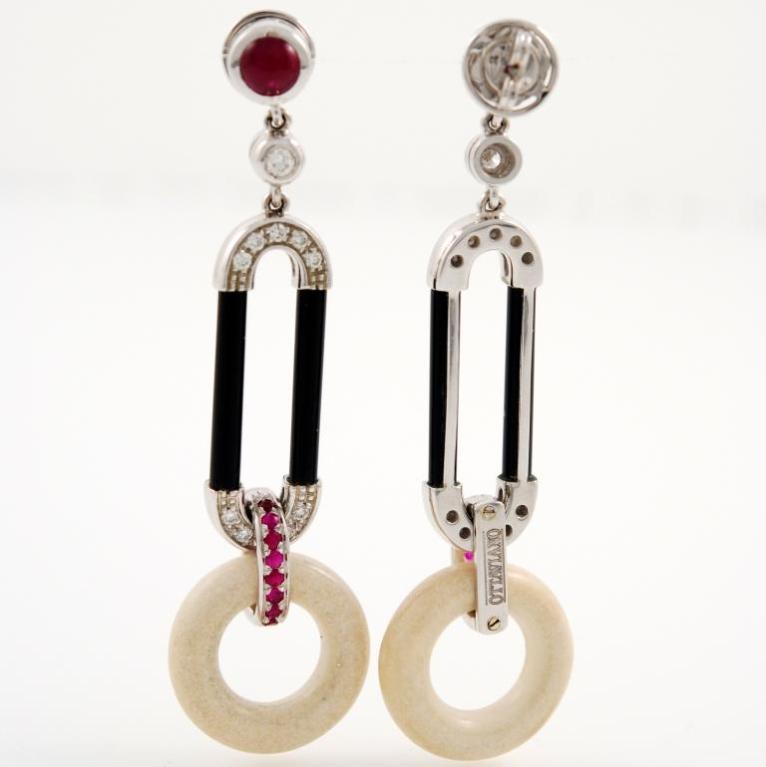 Elegant earrings in 18kt white gold, onyx and circles in cogolo , featuring 0.32 carats of diamonds and 1.58 carats of rubies. Designed by Ottaviano, Italy.