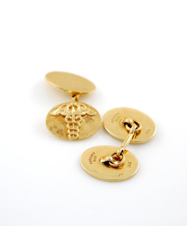 14kt gold cufflinks with the crest of the medical corps.
 Tiffany & Co.
