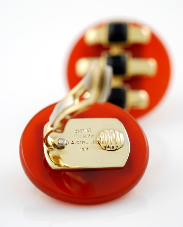 Beautiful 18kt yellow gold, carnelian and black onyx button earclips, 1974. Signed Aldo Cipullo for Cartier.