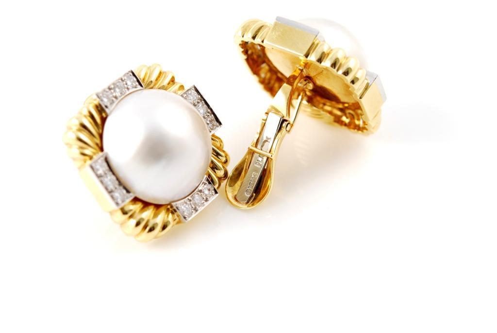 Set with 2 Mabe pearls within squared frames of rope design accented with small round diamonds weighing approximately 1.20 carats, mounted in 18 karat gold and platinum. Signed Webb