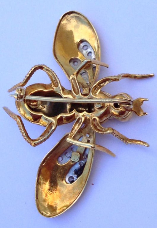 A exquisite 18k yellow gold figural wasp brooch. Vibrant yellow and black guilloche enamel body with platinum and rose cut diamonds (approx .5tcw) Three part riveted construction retains original pin back. A large and stunning item.