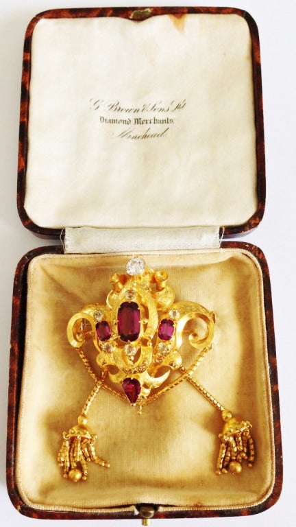 A rare Georgian period gem set pendant brooch. Sculpted and engraved 18k yellow gold setting with prong set gems. Approx. .95ct diamond tops four various cut vibrant rubelite stones (approx. 6ctw) and six cut green beryls Original pin back and box