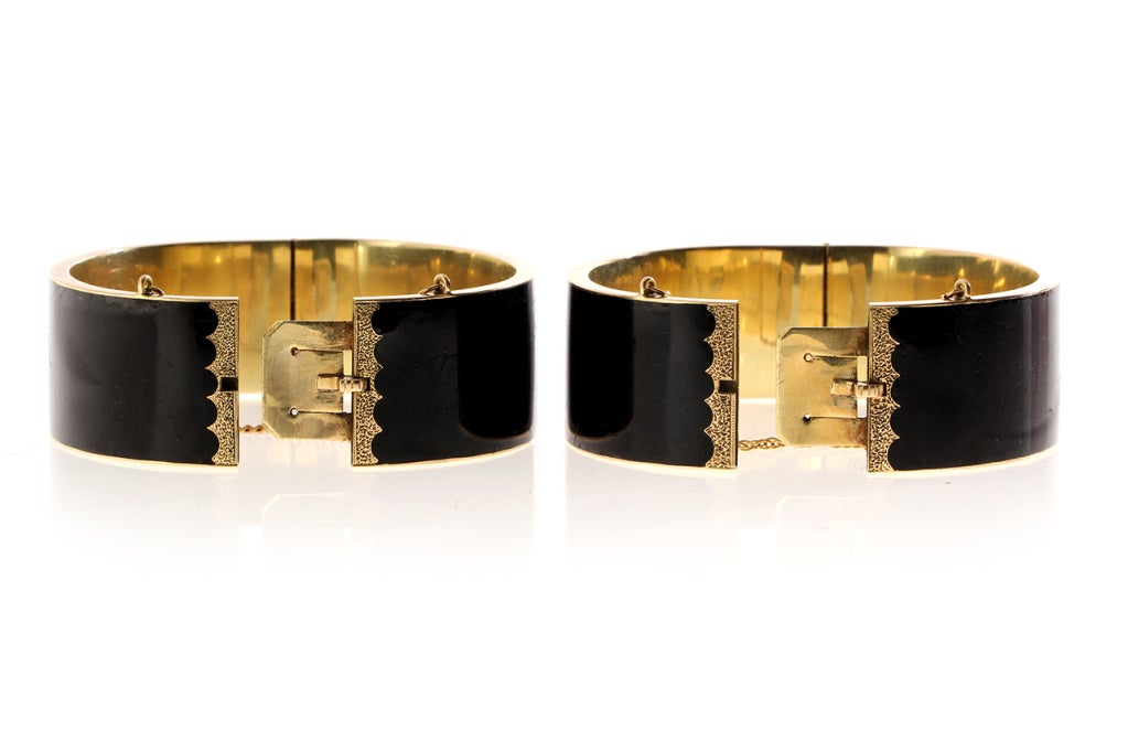 Victorian black enamel bracelets, circa 1860-1880.
14k gold. American in origin. Hinged at side with push-button closure and safety chains. Inner circumference measures approximately 6.25