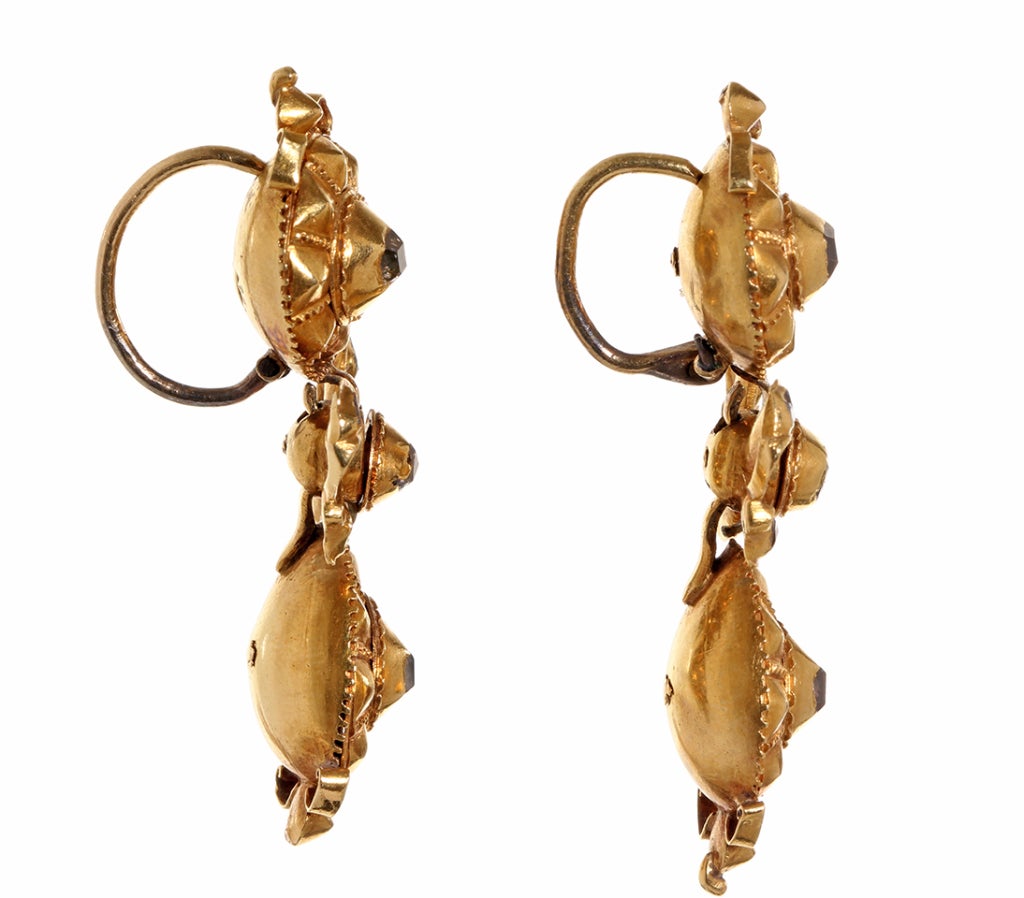 18th century Spanish table cut diamond earrings in 18k gold.  Wearable everyday and a textbook version of an early Spanish earring.  This shape and style is often referenced in texts on jewelry from this time period.  These diamonds were likely from